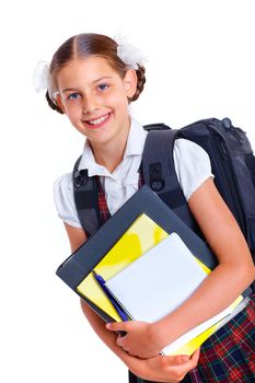 Education theme. Joyful schoolgirl smiling happily with backpack holding book