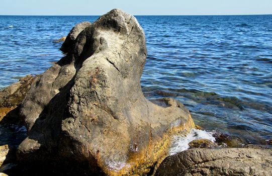 Big beautiful stone on a background of the sea