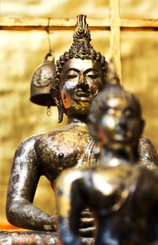Golden buddha statue close-up and depth-of-field