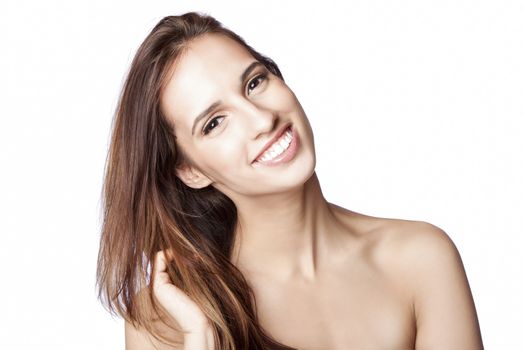 Beautiful happy smiling woman showing teeth with great skin touching her hair, skincare and haircare concept, isolated.