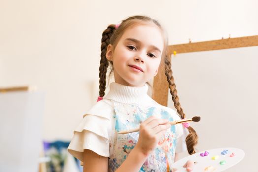 portrait of a girl standing next to his easel, a drawing lesson