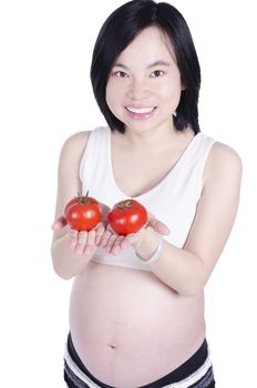 Beautiful pregnant woman with fresh tomato isolated over white background