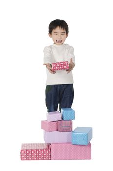 Little boy with gifts on white background