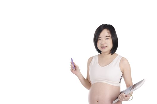 Pregnant woman is writing and reading with white background