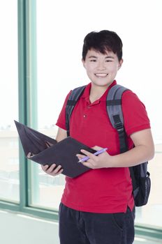 Young pretty Asian student open note and smile