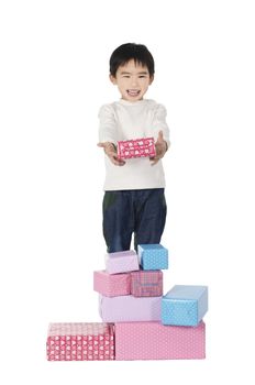 Little boy with gifts on white background