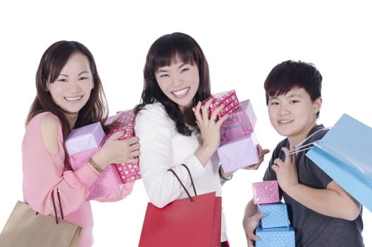 Three pretty girls smiling holding shopping bag and gifts  on white background