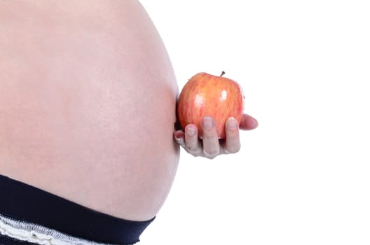Pregnant woman holding fresh apply by hand isolated over white background