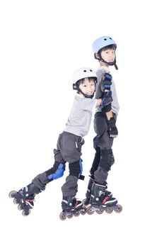 Brothers playing roller blades over white background