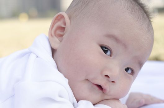 adorable baby look ahead in green area