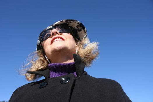 Portrait of a mature woman enjoying the sunlight on a beach.