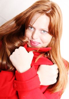 A attractive young, redhead  woman in Winter clothing.  