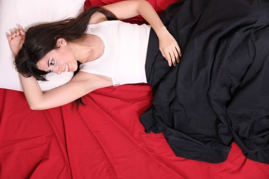 A young hispanic Woman sleeping on the Bed.
