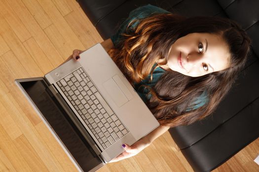 A young hispanic girl with a laptop. 