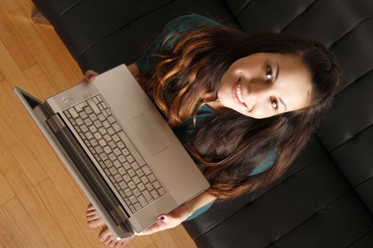 A young hispanic girl with a laptop. 