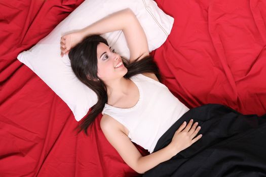 A young hispanic Woman sleeping on the Bed.
