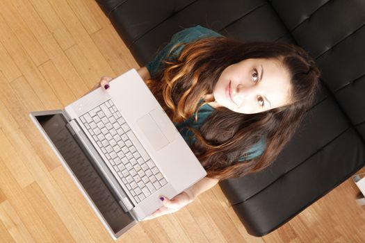 A young hispanic girl with a laptop. 