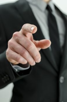 Closeup of businessman pointing finger at you.