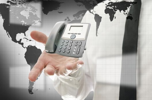 Businessman in interactive space presenting telephone. Concept of global communication.