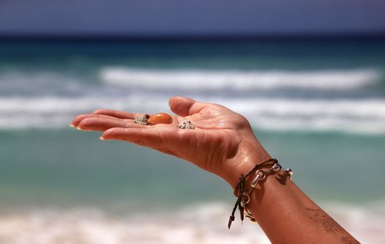 Bowls in a woman's hand isolated on background of the sea