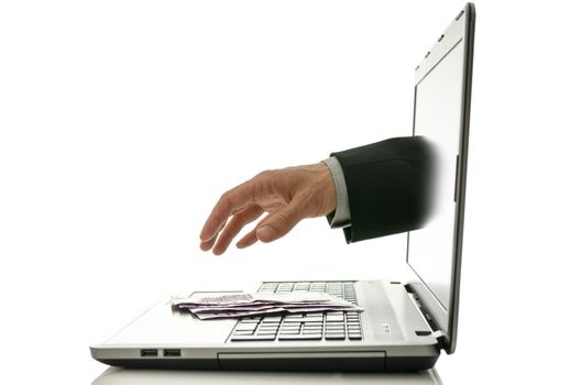 Hand reaching out of laptop screen to steal ones money.