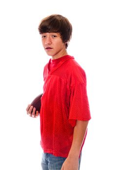 Young teen holding a football in red jersey isolated on white background.