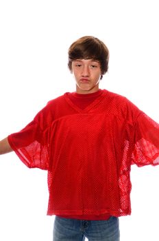 Young teen boy in red jersey and jeans with arms opened on white.