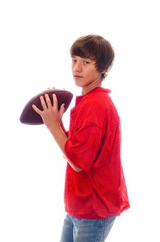 Young teen quarterback holding a football isolated on white.