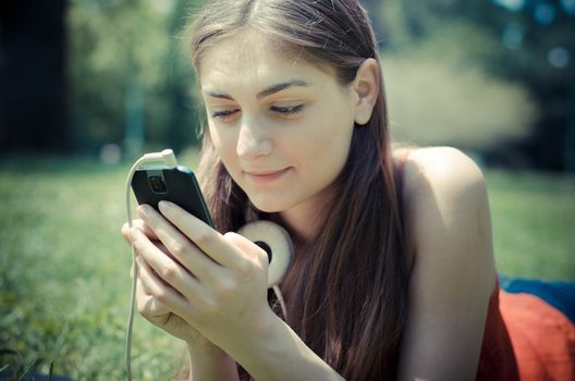 beautiful model young woman on the phone  in the park in spring