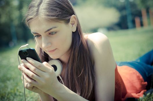 beautiful model young woman on the phone  in the park in spring