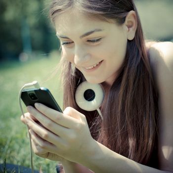 beautiful model young woman on the phone  in the park in spring