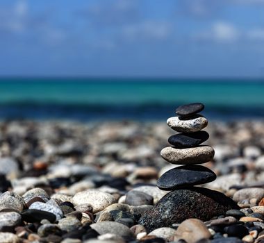 Zen meditation background -  balanced stones stack close up on sea beach