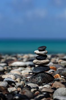 Zen meditation background -  balanced stones stack close up on sea beach