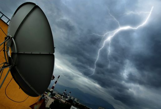 Creative photo of the high-tech parabolic antenna and lightning