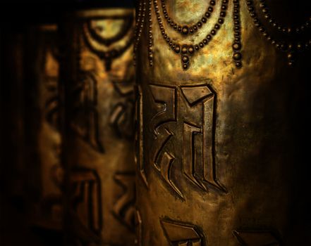 Tibetan Buddhist prayer wheels in Buddhism temple. Shallow depth of field. McLeod Ganj, HImachal Pradesh, India