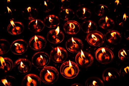 Burning candles in Tibetan Buddhist temple. Himachal Pradesh, India