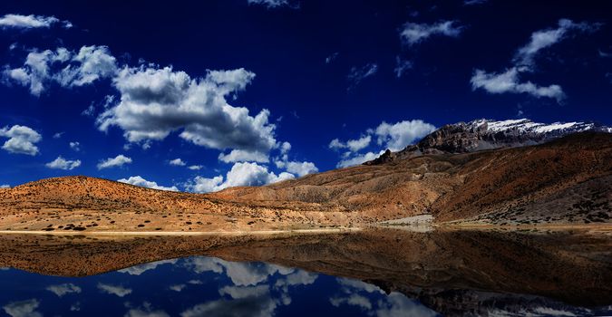 Mountain lake in Himalayas with reflection panorama. Dhankar, Spiti valley, Himachal Pradesh, India