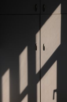 Cabinet and lines of sun light and shadow