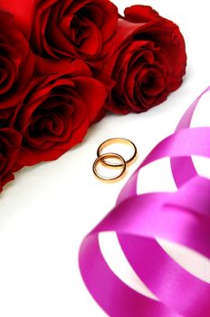 Bunch of flowers and wedding rings with ribbon