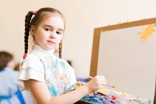 portrait of a girl standing next to his easel, a drawing lesson