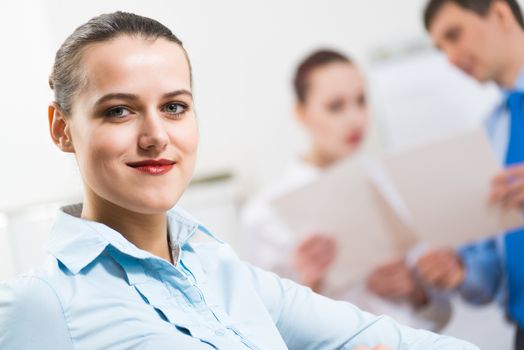 portrait of a business woman in office, smiling and looking into the camera, office work