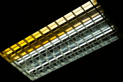 Detail of a fluorescent tube mounted on a wall, false green color light