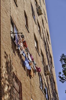 Madrid, August 2012. Laundry drying on a window in a residential building