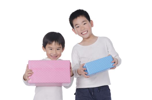 two little boy with gifts over white background