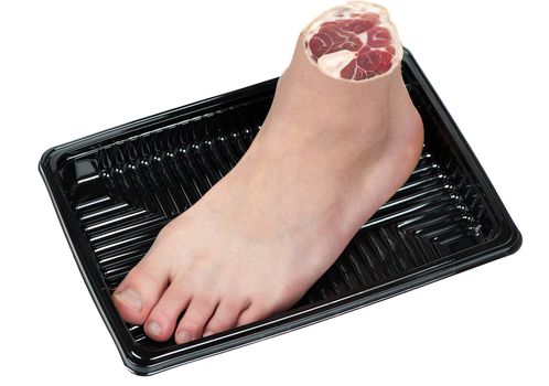 A human foot in a tray symbolizes human trafficking, cannibalism, or severe punishment.