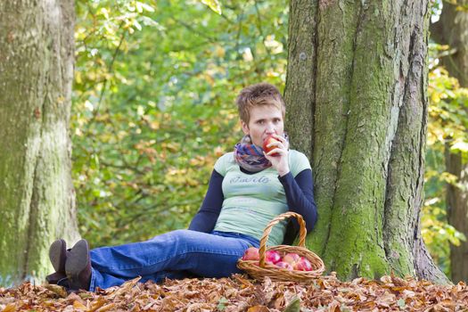 woman with a basket full of red apples 