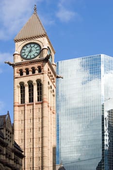 Modern building and old tower on blue sky background