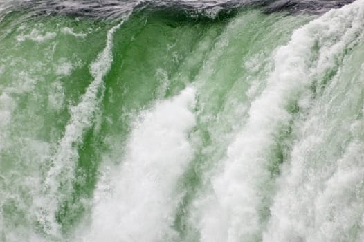 Blue-green water, falling down from Niagara falls.