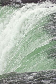 Blue-green water, falling down from Niagara falls.