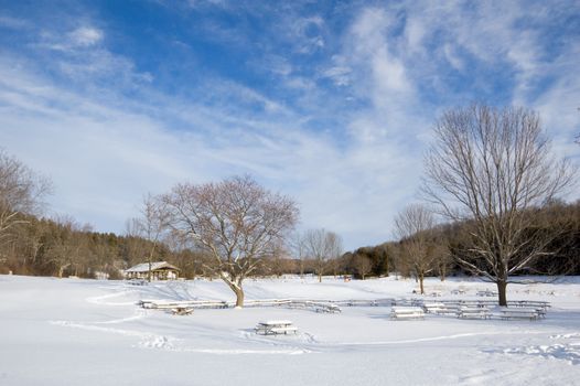 Barbecue tables under snow in Ontario park